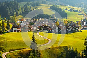 Cozy little mountain village on the hilltop in the background of the Dolomites mountains in Bolzano province