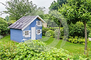 Cozy little playhouse in a green garden