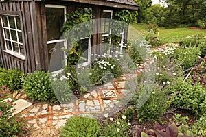 Cozy Little Rustic Shed with Stone and Brick Path in Cottage Garden