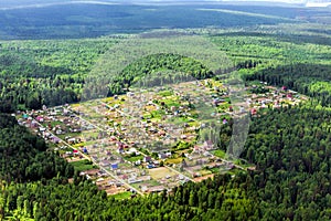 The cozy little village in the middle of taiga forest. Airview