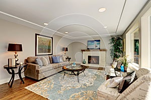 Cozy living room interior with hardwood floor and fireplace.