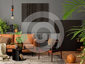 Cozy living room interior with mock up poster frame, brown sofa, leather armchair, black coffee table, books, plants in flowerpots