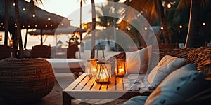 cozy Luxury resort, evening beach, candles blurred light on table ,sofa, hammock on front sunset sea