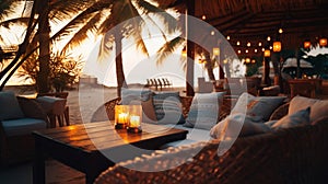 cozy Luxury resort, evening beach, candles blurred light on table ,sofa, hammock on front sunset sea