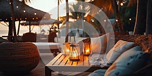 cozy Luxury resort, evening beach, candles blurred light on table ,sofa, hammock on front sunset sea