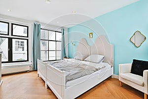 Cozy mansard bedroom with big bed