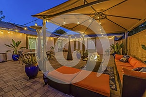 Cozy outdoor seating area under a pavilion on the patio paved with stone bricks