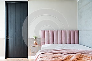 Cozy Pink Bedroom corner with baby pink velvet fabric bed decorated by blanket, pillows and pink floor lamp with two-tone beige