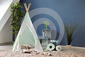 Cozy play tent for kids in interior of room