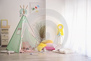 Cozy play tent for kids in interior of room