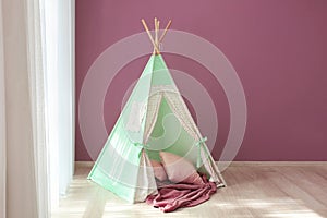 Cozy play tent for kids near window in room