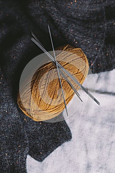 Cozy skein of yarn and needles for knitting socks. Background for handmade and slow homelife