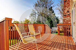 Cozy small backyard with wooden walkout deck