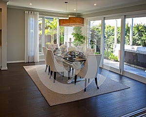 Cozy spaces dining room looking out to garden and BBQ grill