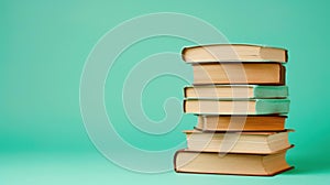 A cozy stack of brown hardbacks sits elegantly on a soft green backdrop, perfect for book lovers and aesthetic enthusiasts