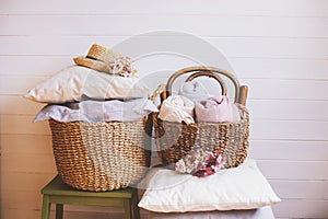 Cozy still life interior details. Organizing clothes in wicker baskets