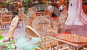 Cozy street cafe with wicker furniture