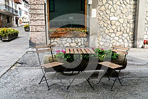 Cozy street chairs and table in heart of Cortina d`Ampezzo, Italy photo