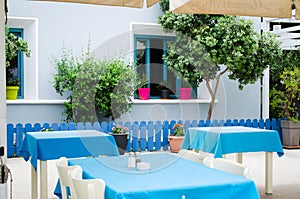 Cozy summer cafe. Tables and chairs on outdoor terrace