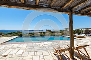 Cozy sun loungers on the mediterranean  terrace with swimming pool near sea