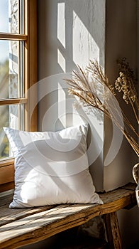 Cozy sunlit corner with pillow and dried flowers