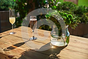 Cozy terrace, Glass with champagne on a wooden table.