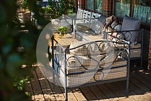 Cozy terrace with sofas for rest, Glass with champagne on a wooden table.