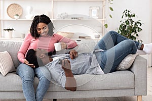 Cozy time at home. Romantic black couple relaxing together on couch