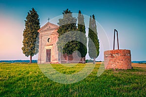 Cozy Vitaleta chapel with water well at sunset, Tuscany, Italy