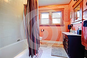 Cozy white and orange bathroom