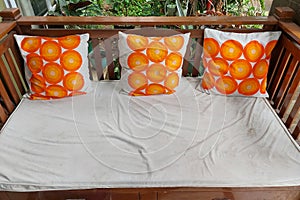 A cozy white sofa with three decorative pillows featuring bright