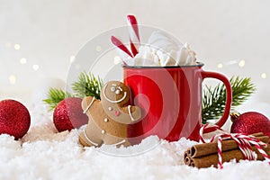 Cozy winter composition with a cup of hot chocolate with marshmallows gingerbread man cookies on a light background