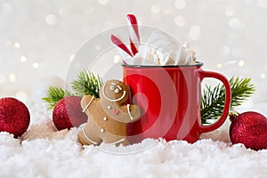 Cozy winter composition with a cup of hot chocolate with marshmallows gingerbread man cookies on a light background