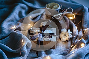 Cozy winter composition with eco gifts and christmas lights, flat lay, mock up