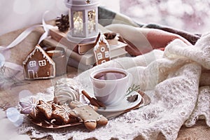 Cozy winter morning at snowy day. Aesthetic windowsill. Atmospheric warm home with books, gingerbread cookies