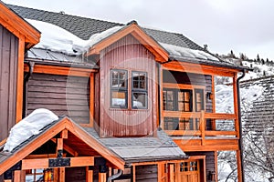 Cozy wooden cabin house in the scenic mountain neighborhood with snow in winter