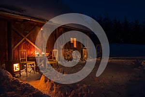Cozy wooden cottage in dark winter forest