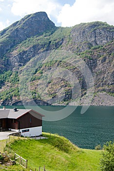 cozy wooden house on coast of beautiful Aurlandsfjord Flam