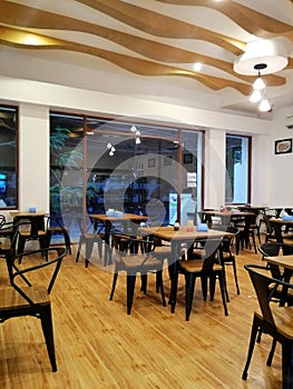 Cozy wooden interior of empty restaurant, copy space. Comfortable modern dining place, contemporary design background