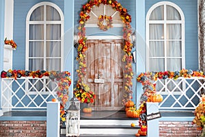 Cozy wooden porch of the house with pumpkins in fall time. Halloween design home