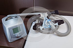 CPAP machine with air hose and head gear mask
