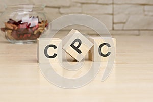 CPC - acronym from wooden blocks with letters, top view on grey background