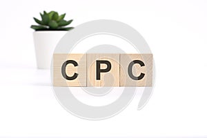 CPC - Cost Per Click - acronym on wooden cubes on white background. business concept