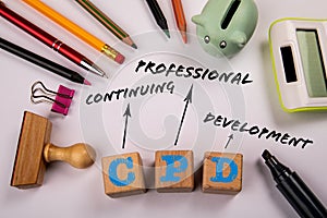 CPD - Continuing Professional Development. Wooden blocks on a white office table photo