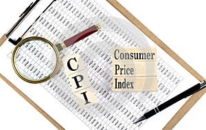 CPI text on wooden block on chart background