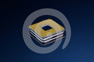 Pin side of CPU Central Processing Unit or microchip computer isolated on dark blue background