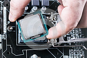 CPU in hand before installation into the motherboard. Top view