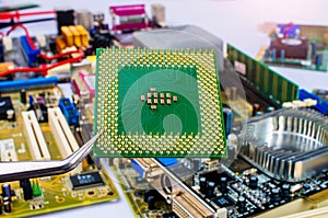 CPU microprocessor, close-up, held by tweezers