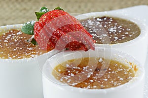 CrÃ¨me Brulee Trio topped with strawberry. photo