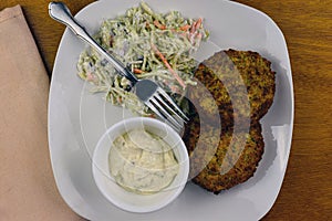 Crab cakes with cole slaw  and tarter sauce photo